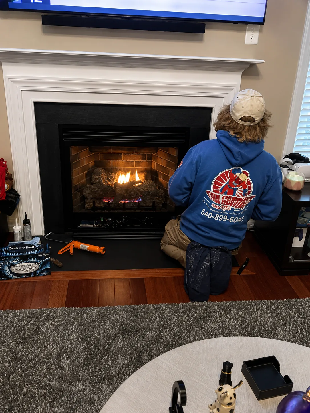 OHA technician servicing a residential gas fireplace