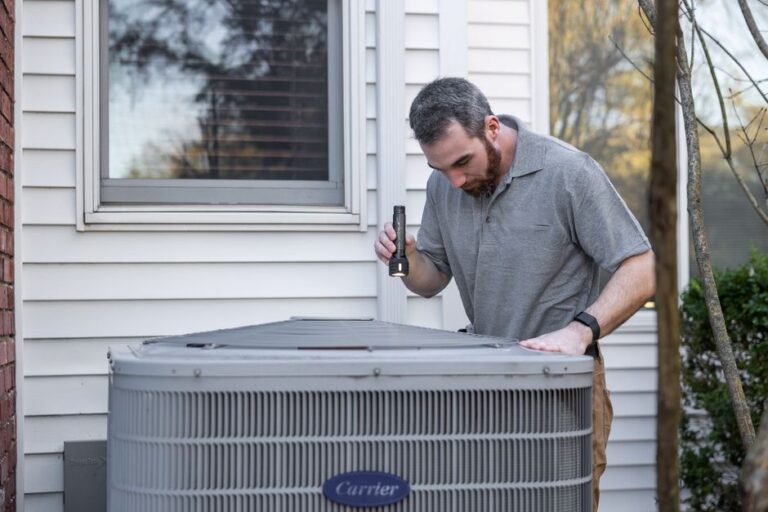 HVAC technician diagnosing an outdoor heat pump at a Woodbridge, Virginia home